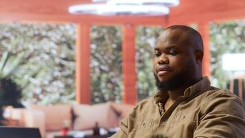Freelancer conducting business analysis and managing online communication, working from home. Self employed man developing a startup using his laptop for strategic planning. Camera B. photo