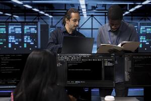 Manager inspecting team of technicians, overseeing data center, looking for firewall misconfigurations. Team leader verifying workers progress in server room, checking if systems bottlenecks are fixed photo