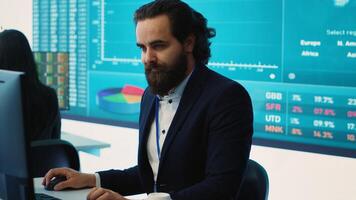 Corporate employee looking into project details and timetables in open coworking space, establishing budget and operations to accomplish goals in a competitive environment. Camera A. photo