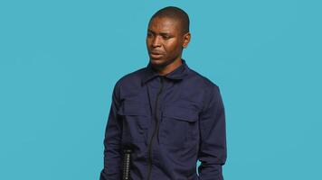 Anxious security guard shaking head, having trouble following orders during protection job shift. Portrait of troubled bodyguard feeling stressed, having problems at work, studio background, camera A photo