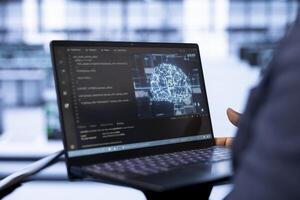 System administrator using laptop in data center, updating AI systems. Close up of device used by server room software developer upgrading artificial intelligence simulation model photo