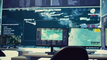 Government anti terrorism operation room equipped with a big display and surveillance on satellite radar cctv used for reconnaissance. Empty military command center with high tech. photo