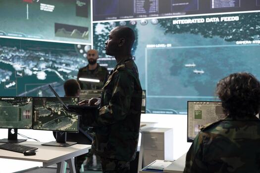 Intelligence analyst comparing satellite surveillance data before transmitting battlefield information to an infantry unit. Soldier working on national defense program, army division. photo