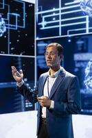 Man speaking at tech expo, exploring latest AI technology trends and case studies. Computer scientist presenting latest artificial intelligence innovations during large event photo