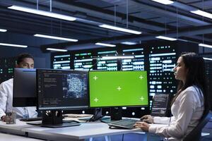 Developer works on isolated screen device in data center with artificial intelligence tech to process datasets. Worker solving tasks on chroma key PC in server hub storing data used for deep learning photo
