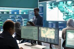 Governmental agency cyber defense team analyzing cyber attacks. IT security professionals working to prevent data breaches and protect against cybercrime, securing digital information. photo