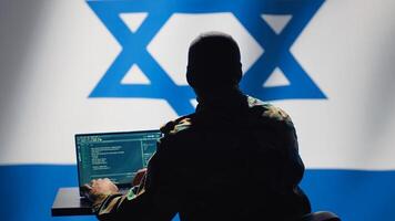 Israel intelligence agency operator uses program deploying bots on social networks, smearing political opponents. Israeli Mossad agent engages in cognitive warfare using troll accounts, camera A photo