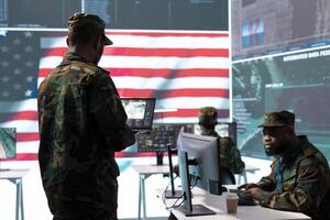 US soldiers in a high tech command center protecting classified information, ensuring cybersecurity and defending against cyber attacks. Army base of operations with trained officers. photo