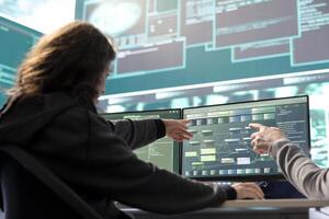 Female governmental hacker examines data on a computer in agency center, using advanced technology to secure national servers. Working on cyber security and defending against threats. photo
