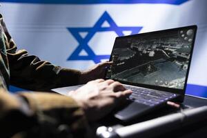 Israeli Air and Space Force unit responsible for Israel air defense, relaying instructions to squadrons patrolling over borders. Military specialist using laptop software to do monitoring photo
