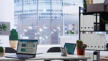 Empty company financial department with stock portfolio on device containing collection of investment assets. Workplace with live index indices on notebook screen showing stock demand surge photo