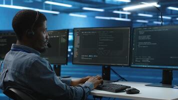 IT support worker remotely collaborating with experts to fix servers providing computing resources for workloads. Man using headphones mic to talk with manager supervising data center supercomputers photo