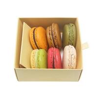 Tasty colorful macaroon in box paper on white background photo