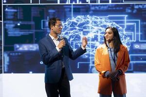 Smiling tech startup managers offer latest AI services during tech summit. Upbeat businesspeople using mic to do presentation for business investors interested in artificial intelligence photo