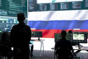 Military hacker from Russian army working in governmental control room cracking rival states network systems to spread fake news and hybrid war propaganda. Brainwashing ideology strategy. photo