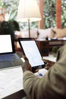 Business owner analyzing blueprints and layouts for a new office space relocation plan, investing in a creative workspace property leasing. Drafting architectural layouts at home desk. photo