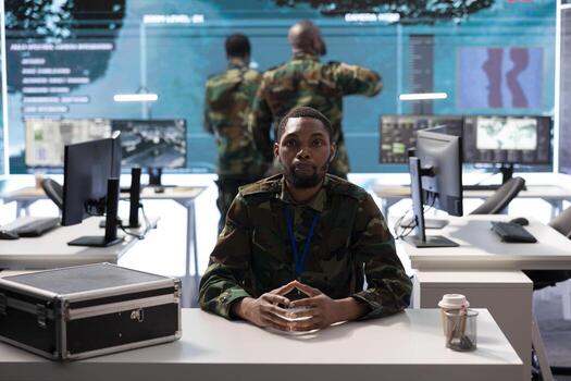 Military crew member participating in a secure online videocall connection, integrating real time data and advanced surveillance technology in a command center for strategic operations. photo