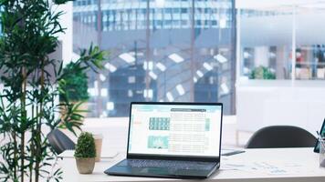 Laptop screen in office showing stock exchange indices changing in real time. Notebook in workspace with forex trading indexes displayed live showing latest price modifications photo