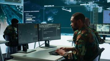 Soldier working with AI intelligence on pc in control room, processing live data on cctv systems. Surveillance efforts to support field missions and defense operations, national security. Camera B. photo