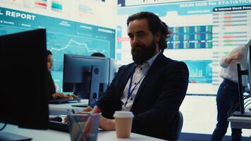 General manager working on data management with infographics and business activity reports, ensuring objective achievement. Shareholder reviewing an investment for global expansion. Camera B. photo