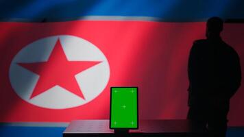 North Korean engineer makes troll accounts with mockup tablet on social media promoting communist ideology. Admin works for Pyongyang regime building algorithms to spread government doctrine, camera B photo