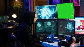 Hacker using green screen PC and AI to find unpatched connections and steal data. Scammer using artificial intelligence and chroma key computer to compromise digital devices, camera A photo