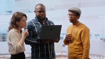 Real estate agent presenting a new office building to clients, discussing the detailed blueprints using a tablet during the property tour. Potential leasing investment opportunity. Camera B. photo