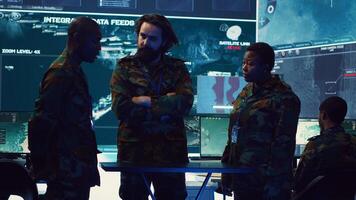 Brigadier general and his staff studying radar data on a holographic image, working with artificial intelligence and holography in a military base of operations. Ensure national safety. Camera A. photo