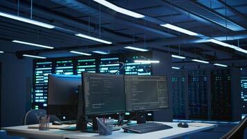 Server rows and computer used to ensure optimal performance and reliability, managing gear. High tech data center facility used for overseeing network connections, panning shot photo