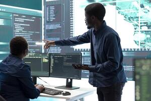 Cyber defense team working in a governmental security operations center. Experts ensuring cybercrime prevention and data breach protection, examining information on a big screen. photo