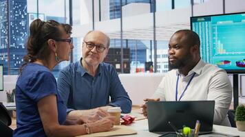 Middle aged people receiving financial advice on retirement planning and life insurance, focusing on increasing their savings with pension plans. Senior couple meeting with banker. Camera B. photo