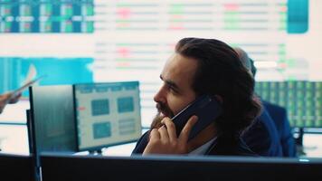 Chief financial officer sharing firm progress on a phone call with the main investor, ensuring performance based on current situation. Administrator works to expand enterprise budget. Camera A. photo