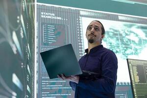 Governmental IT expert at work planning advanced cyber attacks on servers infrastructure to gather information, high tech spyware activity. Hacker breaking into accounts for cyberwarfare. photo