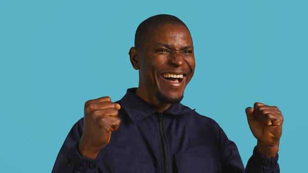 Portrait of security agent celebrating achievements after securing assigned post, studio background. Close up of guardian feeling satisfied after completing tasks, handling security breaches, camera B photo