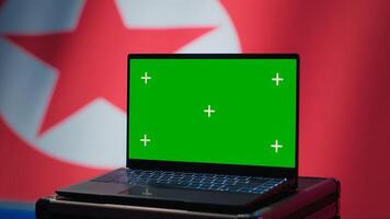 North Korea soldier using radar on green screen laptop to detect missiles during korean conflict. Pyongyang regime army soldier scanning rockets with chroma key notebook, close up shot, camera A photo