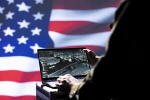 USA FBI agent combating organized crime and terrorism using detection system on laptop, close up shot. American officer protecting national sovereignty by tracking terrorists entering country photo