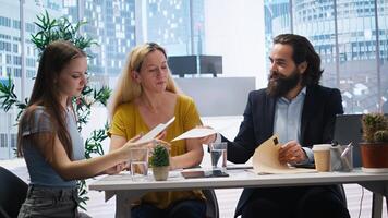 Financial advisors meeting with clients to counsel them on their finances and give them personalized financial plan. Agent guiding family in making profitable and secure decisions, camera A photo