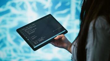 Engineer uses tablet and AI deep neural networks modeled after human brain to solve complex problems. Close up of admin using machine learning model to look at data and better complete tasks, camera A photo