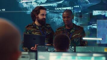 Commanders team conducting briefs to inform and update their troops on mission status and objectives, employing military satellite from a power base of operations. Information gathering. Camera A. photo