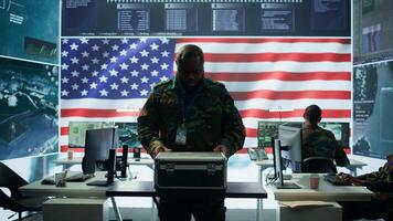 American military officers in cyber command center protect state secrets, manage classified information and engage in high tech digital warfare to ensure cybersecurity and data protection. Camera B. photo