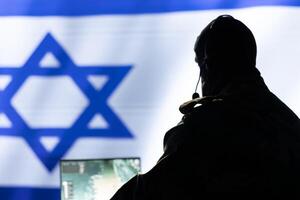 Israeli IDF army conducts tactical reconnaissance, utilizing laptop for data analysis and mission planning, close up. Israel Defense Forces agent looks at aerial map on screen, pinpointing targets photo
