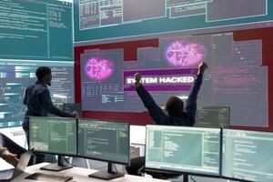 Group of governmental hackers successfully breaking into servers to steal important data, experts feeling happy and proud of their criminal achievement. Espionage system in high tech agency. photo