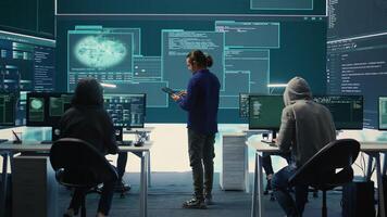 Happy cheerful hackers team gaining access inside network systems, celebrating their achievement and the step forward during hybrid war activities. Pleased experts stealing database info. Camera B. photo