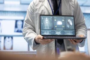 Physician presenting a ct scan result for heart and brain analytics during a meeting with medical staff, examining electrocardiogram tests on laptop. Licensed medics discuss recovery plan. photo