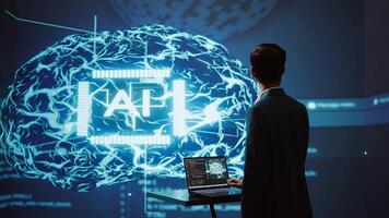 System administrator uses neural networks modeled after human brain to solve complex problems. AI researcher in futuristic workspace using artificial intelligence to look at data, camera B photo
