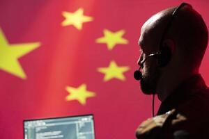 Chinese army communication systems operator using radio and satellite equipment, providing combat support. Military dispatcher managing communications networks, isolated over China flag photo