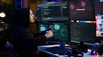 Cheerful hacker in apartment doing energic celebration after managing to steal sensitive data. Scammer happy after obtaining sensitive information from users using malware, camera A photo