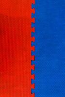 Easily interlocking puzzle shaped rubber floor mats to prevent falling shock hazards are widely used in gyms and children's rooms to prevent potential hazards. The background is a blank rubber bumper. photo