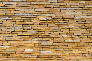 Brick wall background is a wall made of clay bricks, giving the structure strength and cement line between bricks that looks beautiful. It is popular to build a wall of ancient monuments.copy space, photo