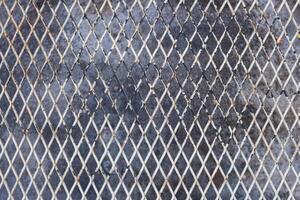 A metal grid background was used to create a high-altitude walking grate as it was lighter than concrete and was visible below. Full frame metal grid backgrounds are perfect for design projects. photo